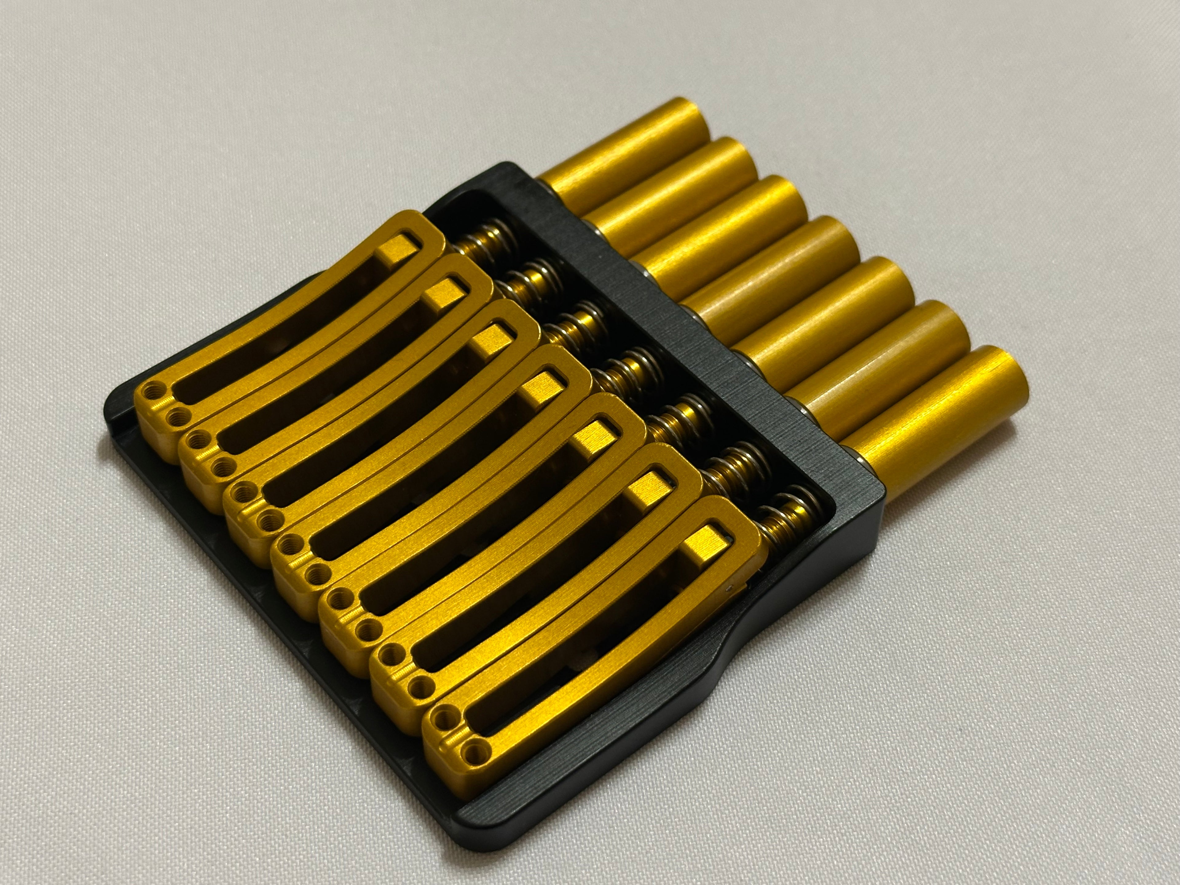 Rakhvari 7 String Hardtail Bridge - Black Baseplate / Gold Hardware