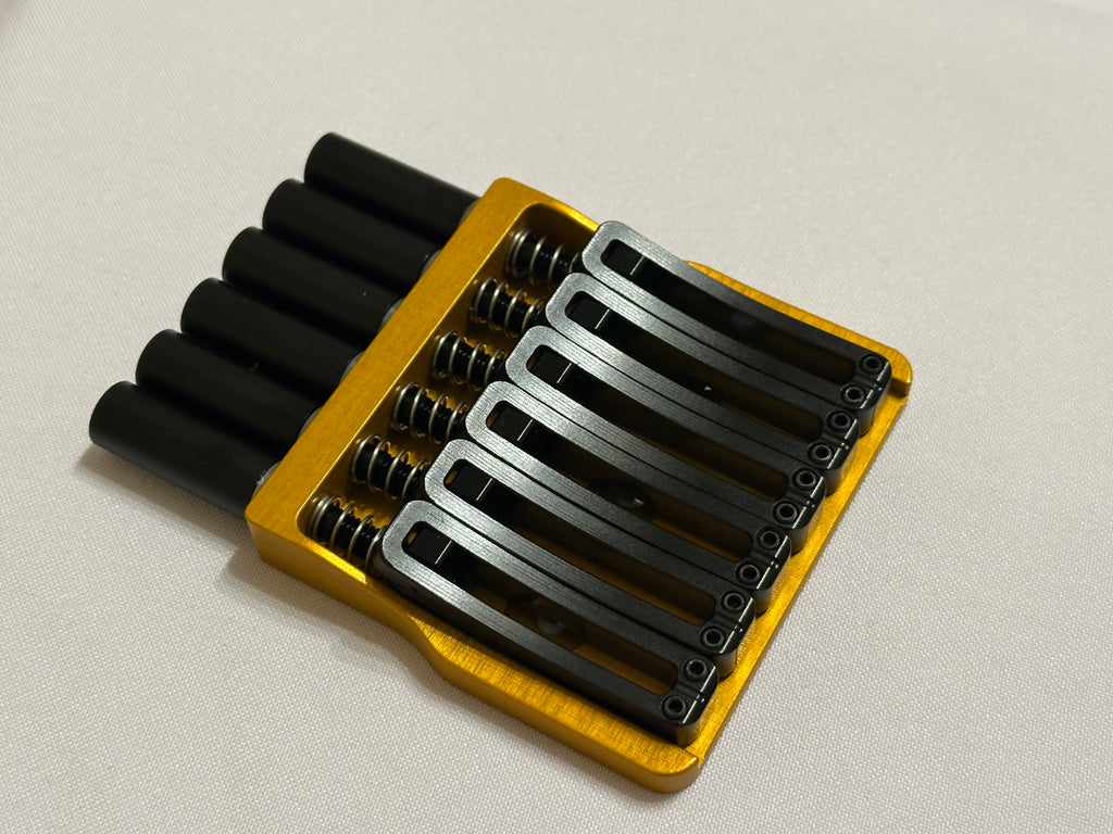 Rakhvari 6 String Hardtail Bridge - Gold Baseplate / Black Hardware