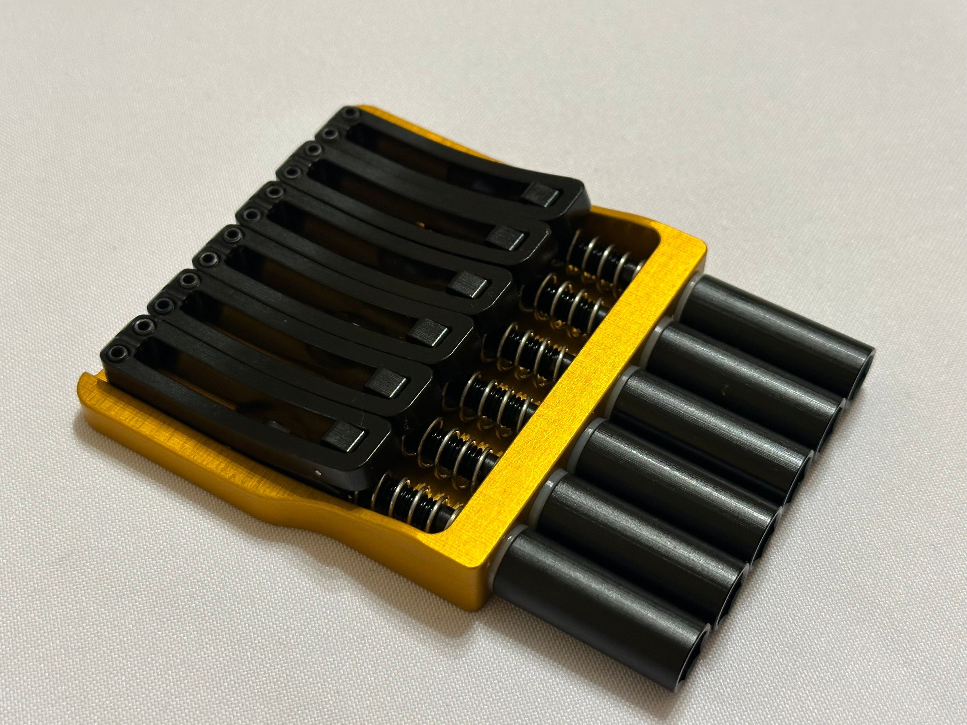 Rakhvari 6 String Hardtail Bridge - Gold Baseplate / Black Hardware