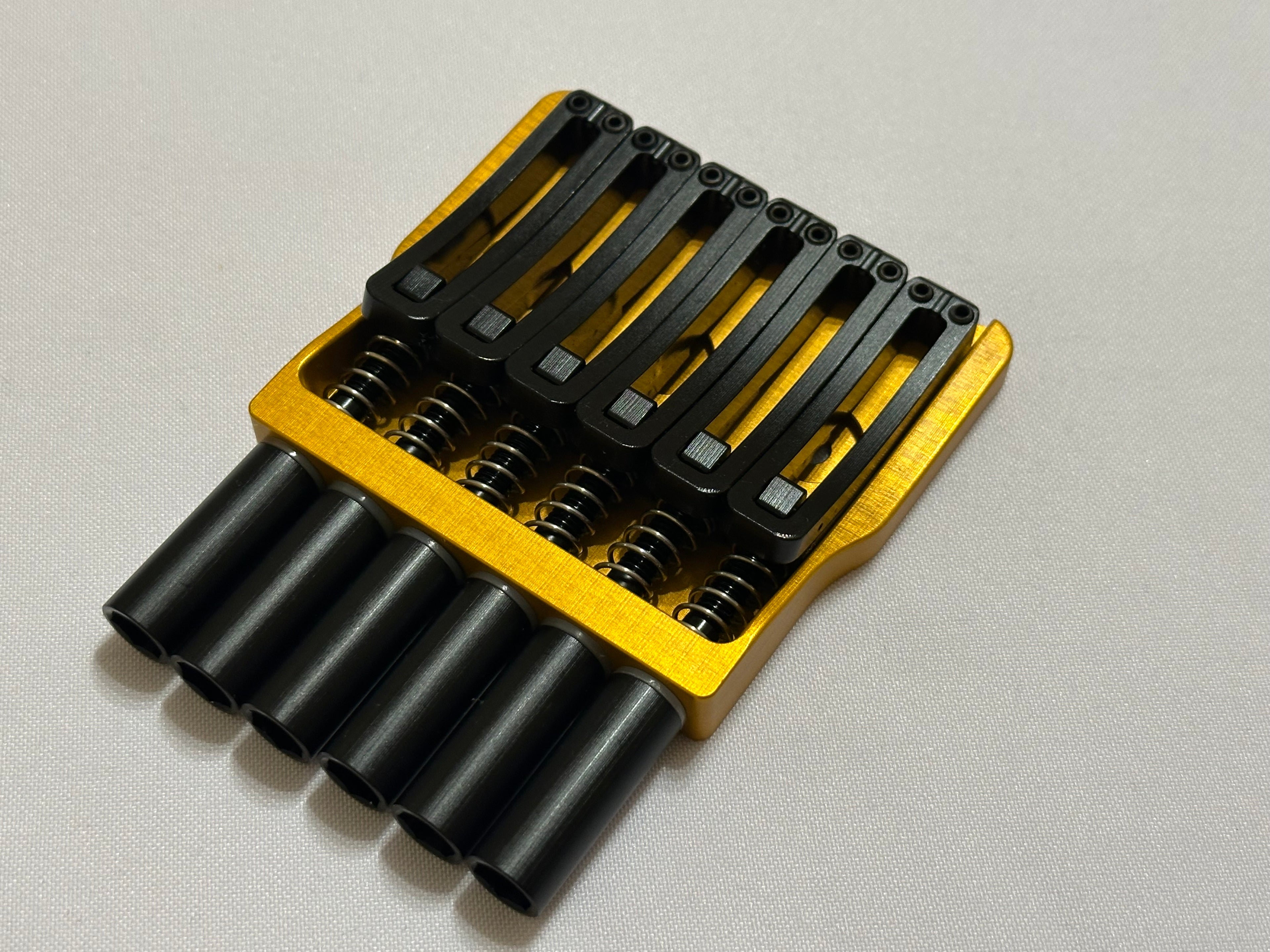 Rakhvari 6 String Hardtail Bridge - Gold Baseplate / Black Hardware