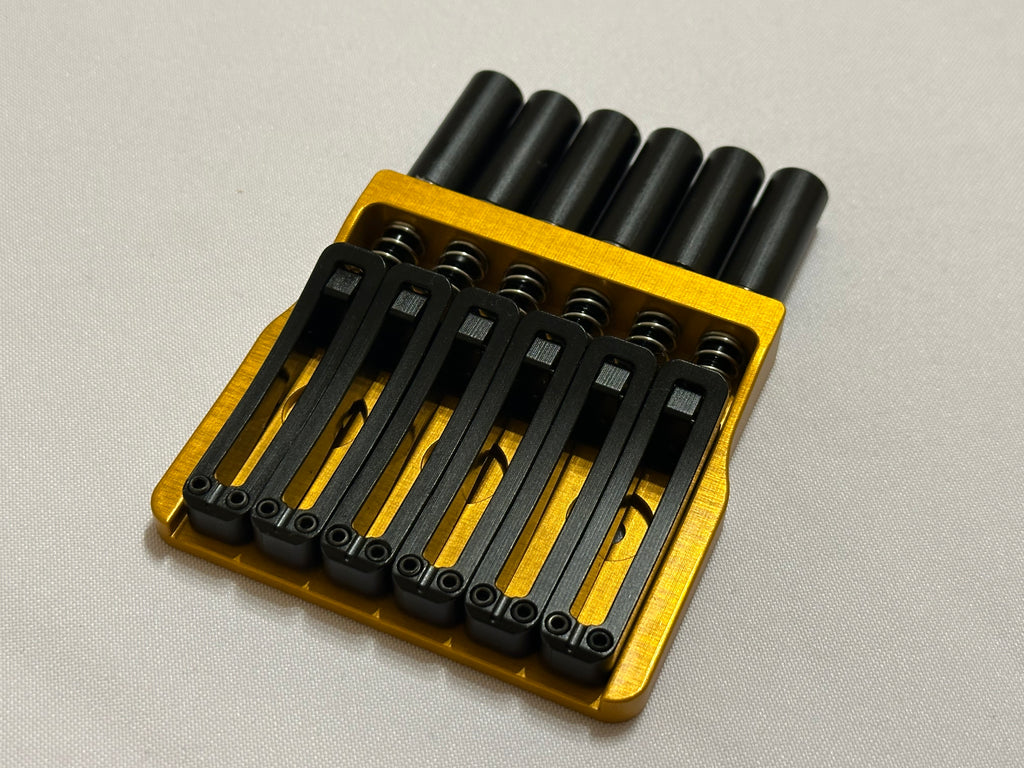 Rakhvari 6 String Hardtail Bridge - Gold Baseplate / Black Hardware
