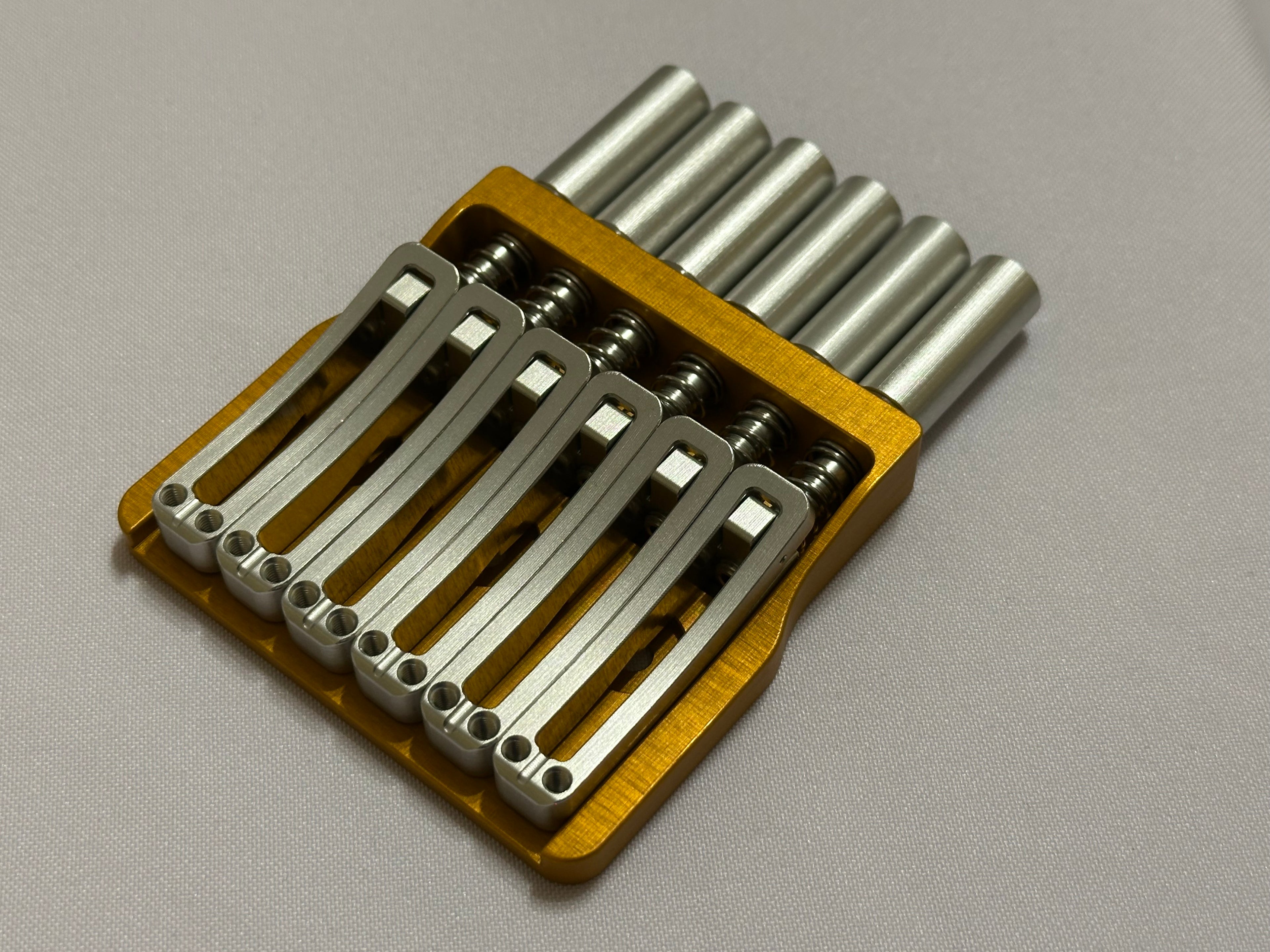 Rakhvari 6 String Hardtail Bridge - Gold Baseplate / Silver Hardware
