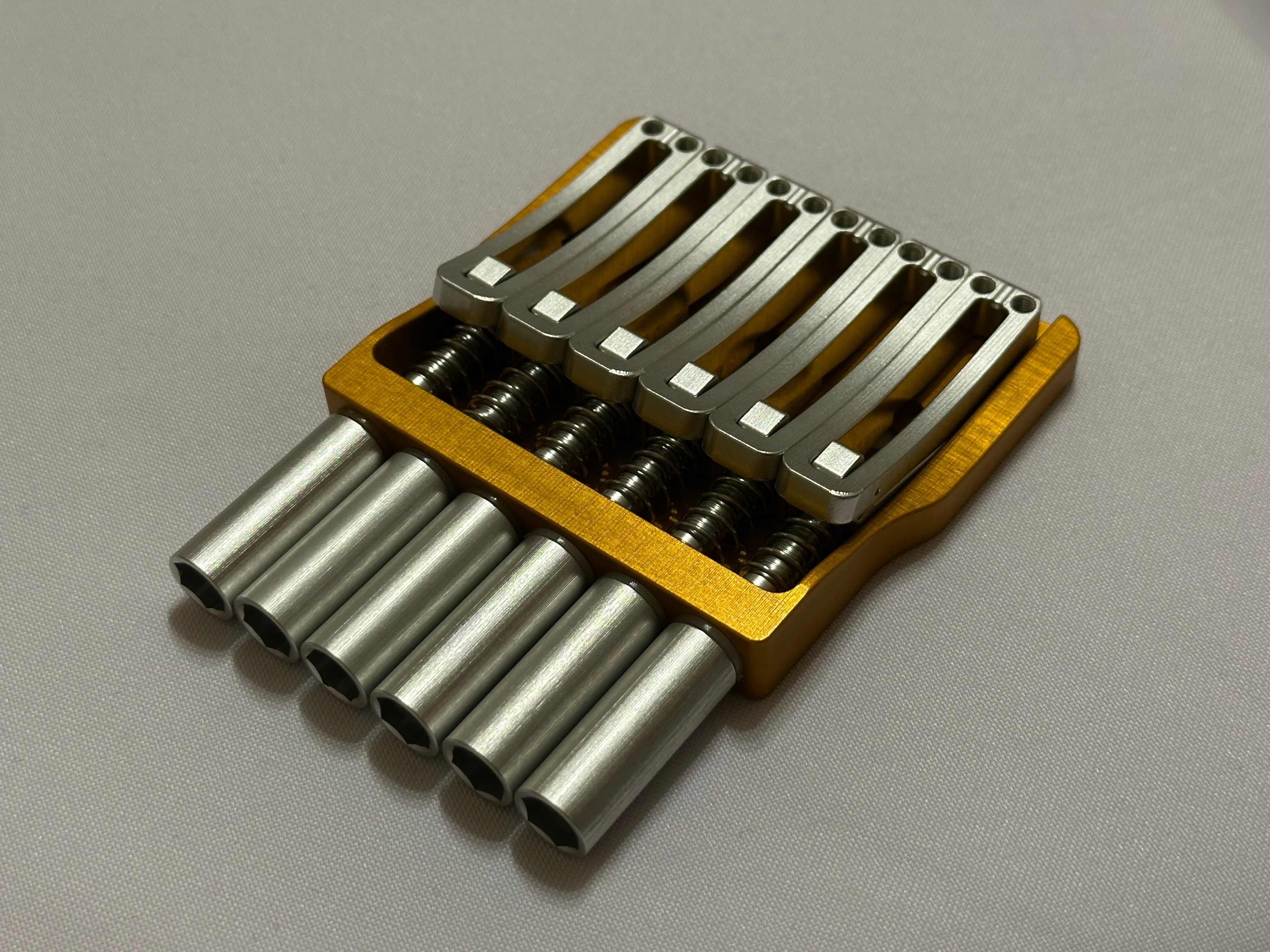 Rakhvari 6 String Hardtail Bridge - Gold Baseplate / Silver Hardware