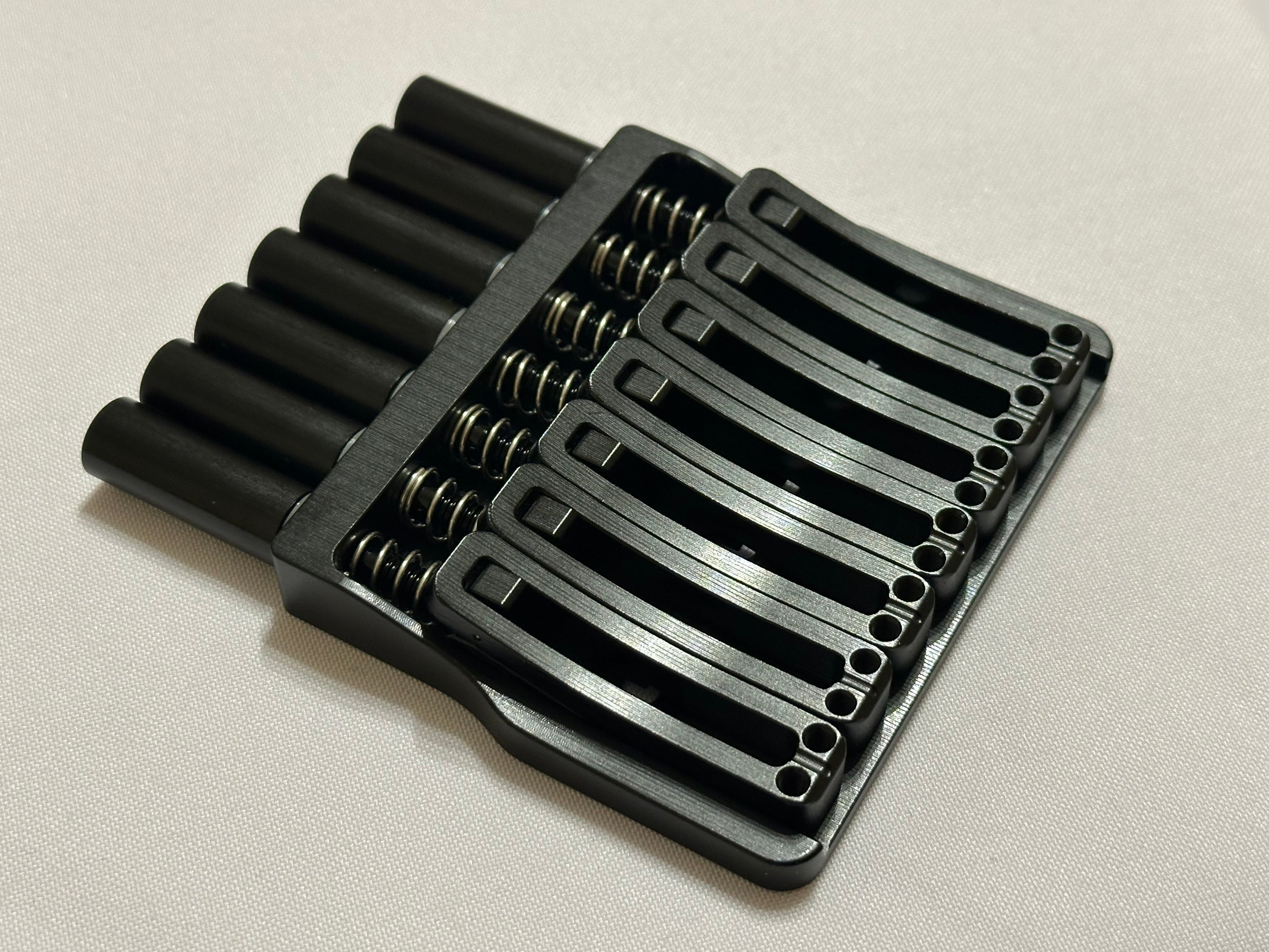 Rakhvari 7 String Hardtail Bridge - Gold Baseplate / Black Hardware