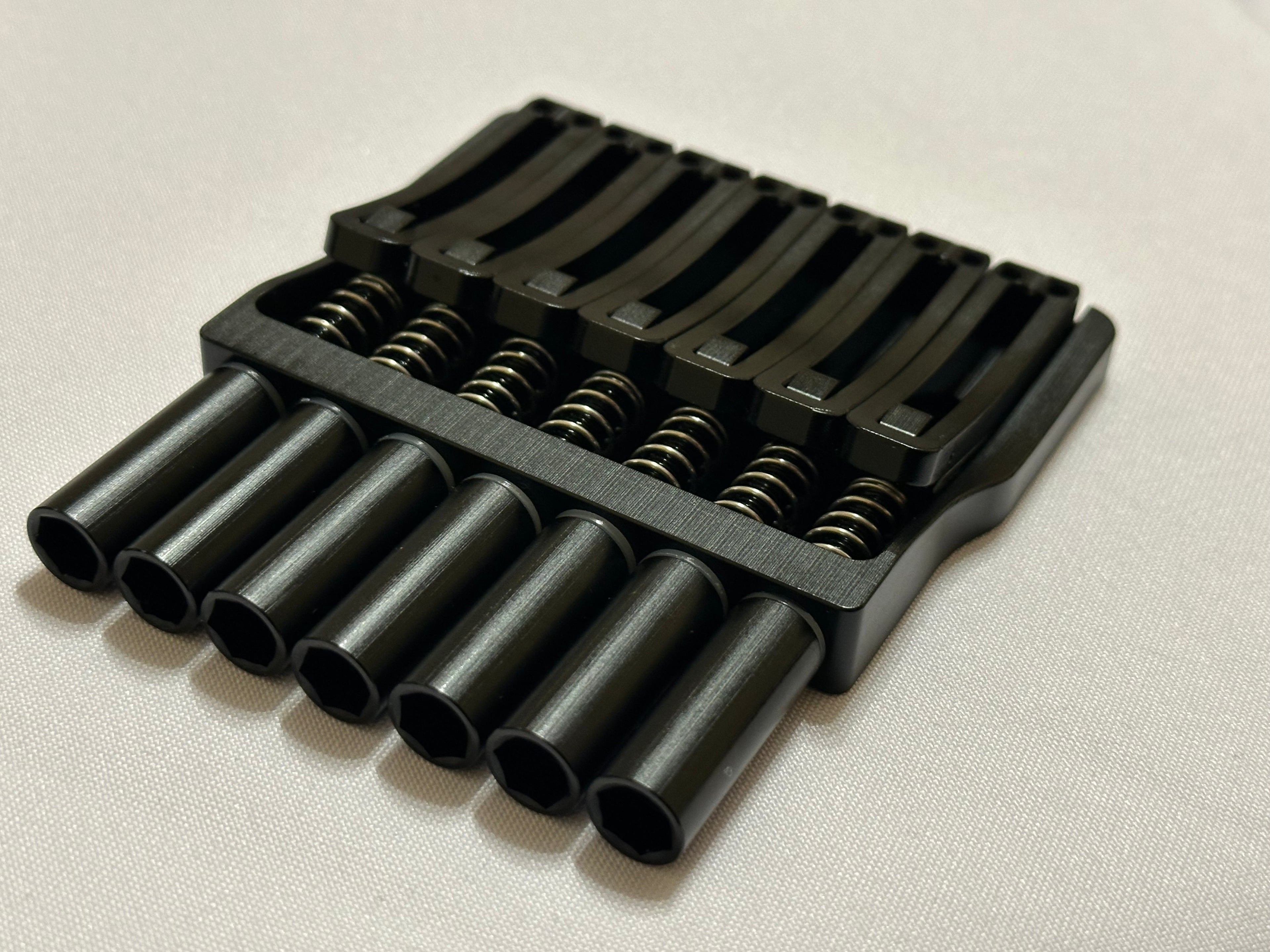 Rakhvari 7 String Hardtail Bridge - Gold Baseplate / Black Hardware