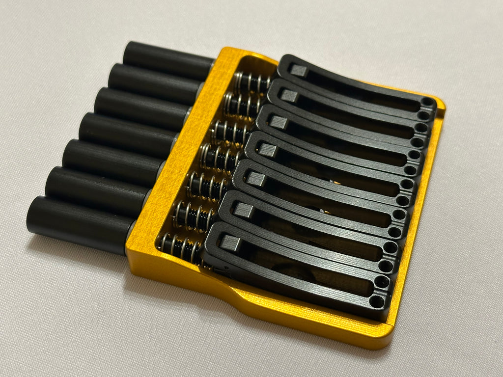 Rakhvari 7 String Hardtail Bridge - Gold Baseplate / Black Hardware